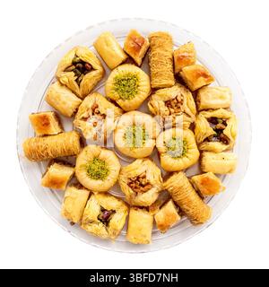 top view of various baklava on round plate cut out on white background Stock Photo