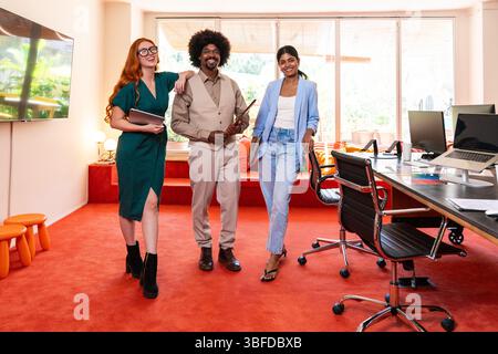 Multiethnic small group of businesspeople meeting in a coworking corporate company office - Young coworkers colleagues working together in a creative Stock Photo