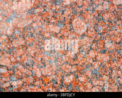 polished red granite board on wall of house in Kapan town, in Syunik Province of Armenia Stock Photo