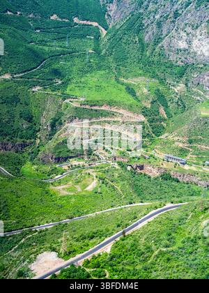 aerial view of mountain valley with Vorotan River Gorge with Devil's Bridge and serpentine road between Tatev and Halidzor villages from Wings of Tate Stock Photo