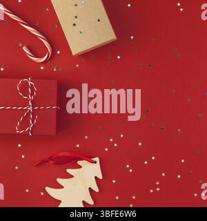 New Year Christmas presents ribbon flat lay top view Xmas holiday 2019 celebration handmade gift boxes red paper golden sparkles background copyspace. Stock Photo