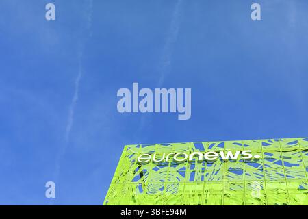 Euronews, european pay television news network brand logo on its headquarter office building located in eco-district Confluence. Blue sky background w Stock Photo