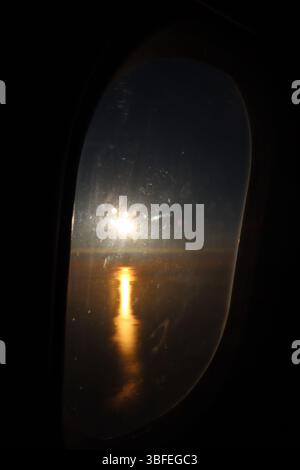 Sunset from a plane’s window over the Mediterranean Sea Stock Photo