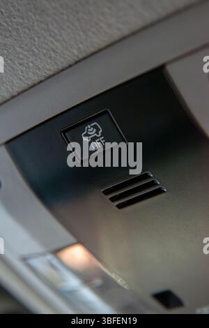 Close up of cabin car ceiling lamp, light control panel inside interior. Off button. Stock Photo