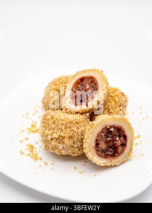 traditional sweet steamed dumplings with a plum jam on white plate Stock Photo