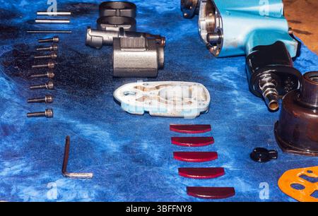 Disassembled pneumatic tool on the table. Pneumatic impact wrench. Stock Photo