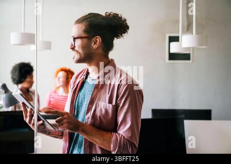 Leadership, tablet and hipster startup programmer CEO or manager in the office. Technology planning. Stock Photo