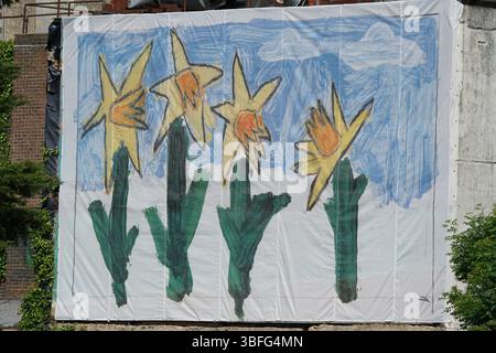 Large Artistic Banner Featuring Hand-Painted Yellow Flowers and Blue Sky Design. Portsmouth, UK Stock Photo