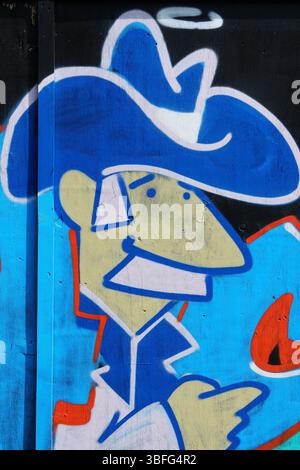 Colorful Urban Street Art Depicting a Cartoon-Style Cowboy Character. Portsmouth, UK Stock Photo