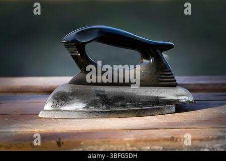 Antique electric Iron. Tool for Traditional Clothes Pressing Stock Photo