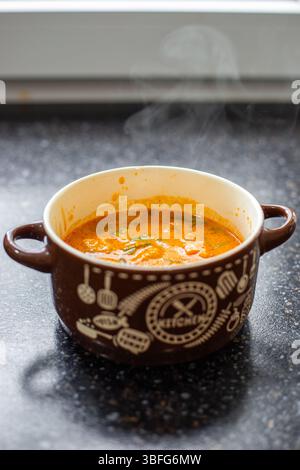 Massaman curry in a clay bowl with handles. Hot spicy Thai dish. Stock Photo
