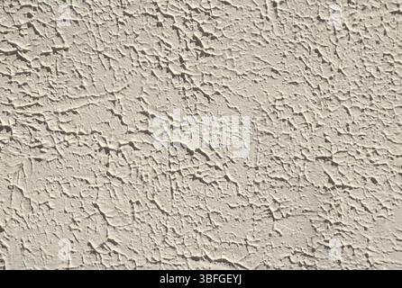 High-resolution full-frame image beige stucco wall texture rough, cracked plaster surface. architectural background. construction design, or abstract. Stock Photo