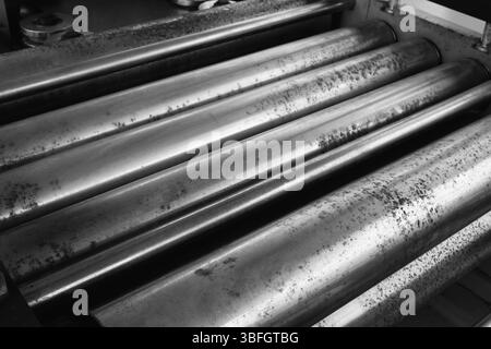 A row of metal rods, some of which are bent and twisted. The rods are arranged in a line, with some of them overlapping each other. Scene is somewhat Stock Photo