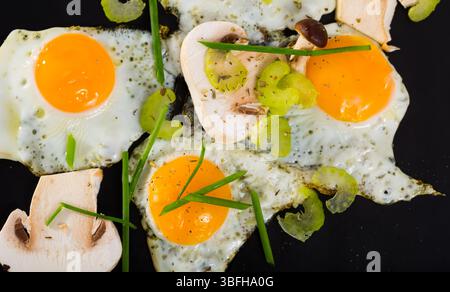 Closeup of fried quail eggs with champignons Stock Photo