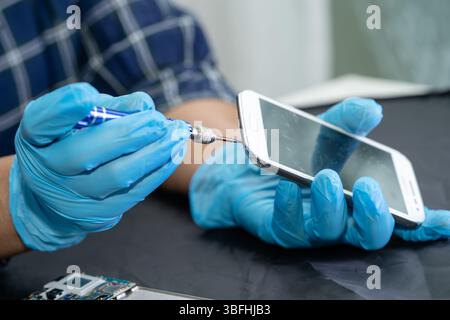 technician repairing inside of hard disk. Integrated Circuit. the concept of data, hardware, technician and technology. Stock Photo