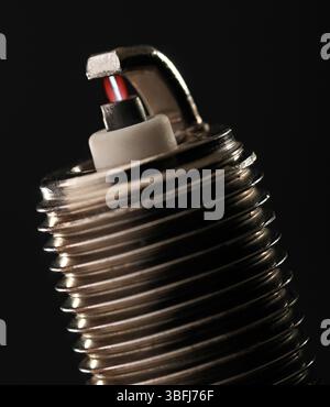 Spark Plug with an ignition spark, close up Stock Photo