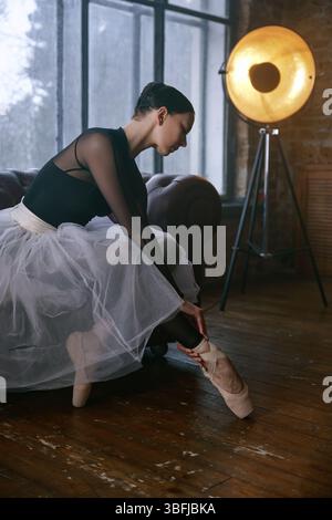 An elegant ballet dancer captured in a beautifully designed studio setting Stock Photo