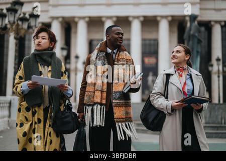 Group of people walking outdoors in stylish attire and engaging conversation Stock Photo