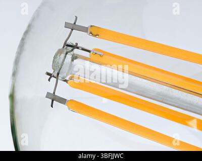 Macro shot of LED Filament type lamp on white background. Stock Photo