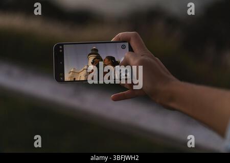 Kissing young couple taking selfie with smartphone Stock Photo