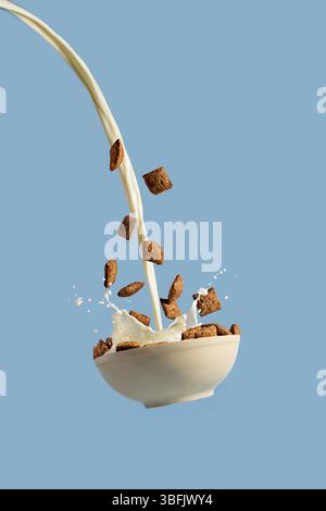 Levitating bowl with chocolate cereals nougats and milk Stock Photo