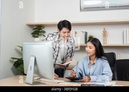UX and UI Design Collaboration. Young designers discussing project ideas and color selections at a modern desk. Stock Photo