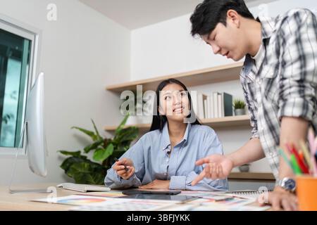 Engaging UX and UI Design Session. Designers collaborating on project ideas in a modern workspace. Stock Photo