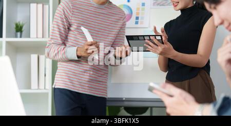 Collaborative UX UI Design Discussion. Team members exchanging ideas on design elements. Stock Photo