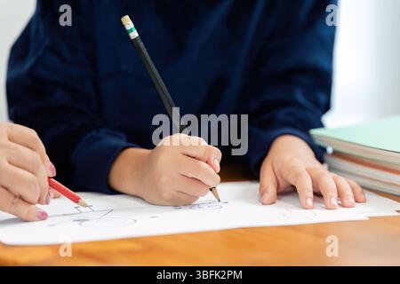 Back to School and Creative Learning. Two students engaged in drawing and sketching on paper, preparing for the new school year. Stock Photo
