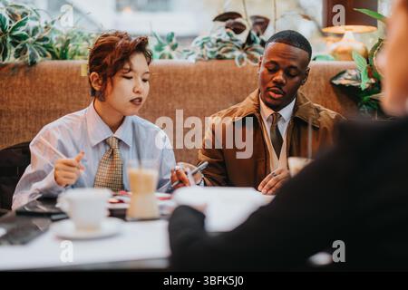 Collaborative Business Discussion Between Multiracial Professionals, Teamwork Atmosphere Stock Photo