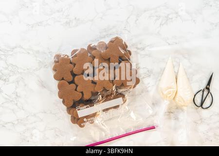 Decorating Gingerbread Man Cookies with Royal Icing for Festive Occasions Stock Photo