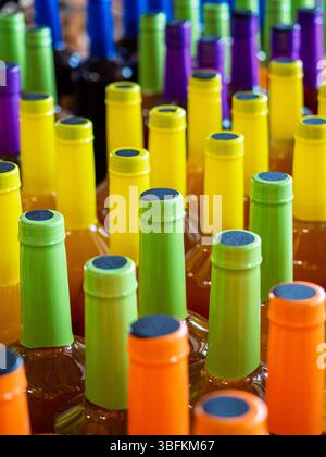 Colorful bottle tops with green, orange, yellow, and purple as an abstract design. Stock Photo