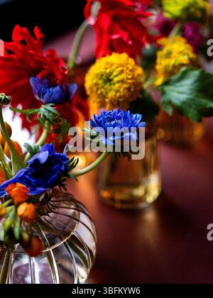 Colourful flowers set on tables at an event. Stock Photo