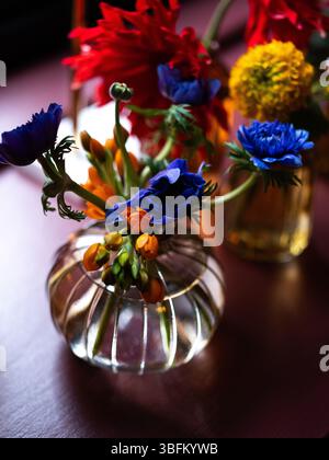Colourful flowers set on tables at an event. Stock Photo
