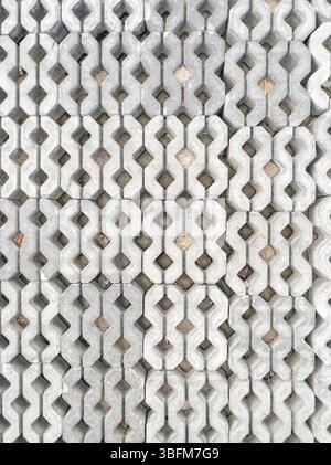 Close-up of patterned concrete blocks in a park walkway, Perfect for landscaping, urban design, and outdoor projects, above view for background. Stock Photo