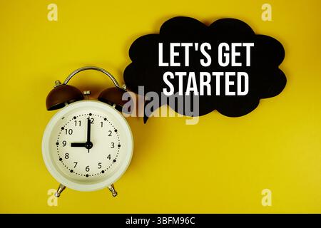 Let's Get Started text on speech bubble top view on yellow background Stock Photo