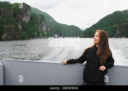 Confident woman with youthful look on fjord cruise near Bergen, Norway Stock Photo