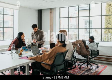 Team of multiracial male and female entrepreneurs working together at tech start up office Stock Photo