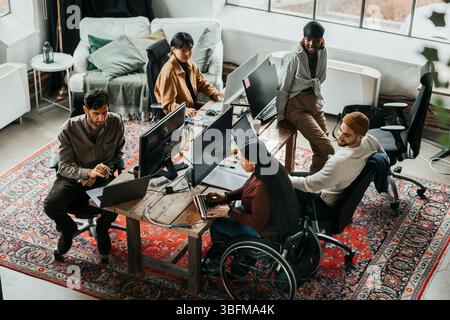 Team of programmers working together at tech start up office Stock Photo