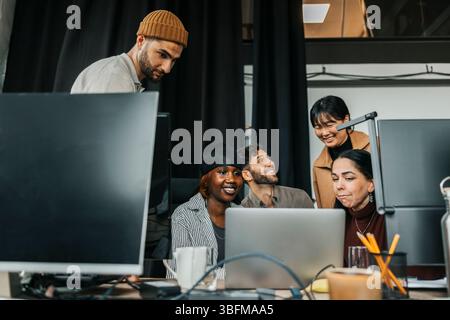 Team of happy computer programmers at tech start up office Stock Photo