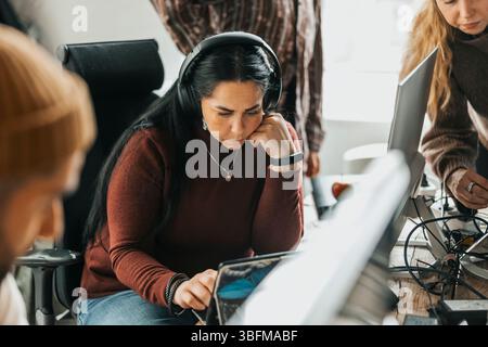 Focused female programmer using digital tablet at office Stock Photo