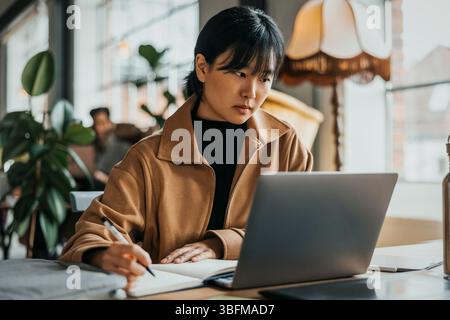 Young female entrepreneur with bangs working at office Stock Photo