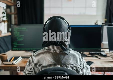 Rear view of female computer programmer doing coding at office Stock Photo