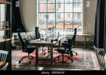 Empty modern office interior with computers on chairs and tables Stock Photo