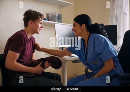 Happy doctor examining patient in medical clinic Stock Photo