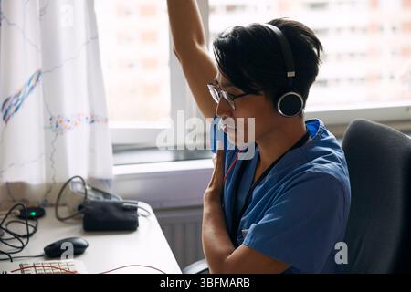 Young doctor explaining over video call at desk Stock Photo