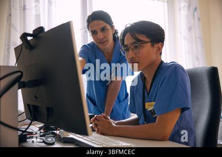Doctors having discussion over computer in clinic Stock Photo