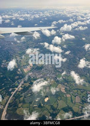 01 JUNE 2025 - London, UK - Flying into Heathrow and passing over London and the M25 with small white fluffy clouds Stock Photo