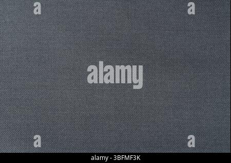 Detailed view of dark gray fabric with subtle texture that can enhance designs and textiles for various applications. Stock Photo