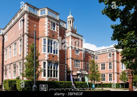Historic red brick newcastle university building with white accents and a prominent clock tower on a clear sunny day Stock Photo